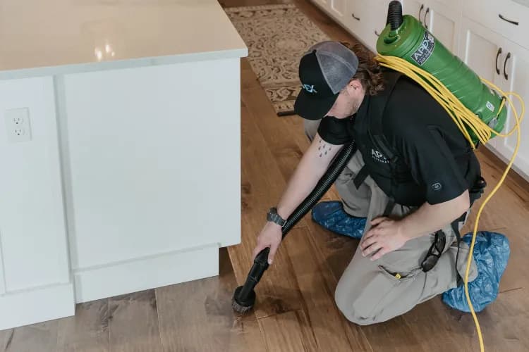 Apex Restoration professional performing Water Damage Restoration for customer in Spokane Valley